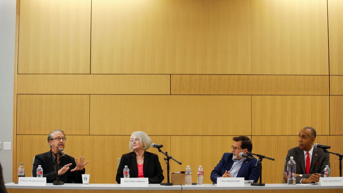Law school deans and panelists participating in workshop discussions.