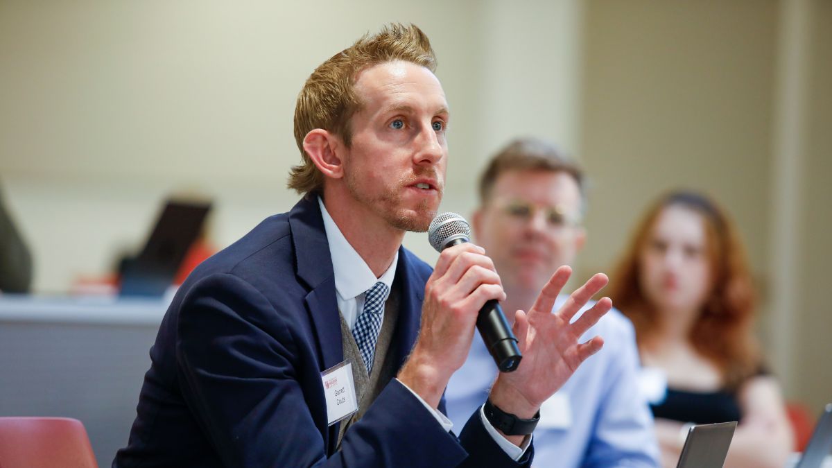 Workshop participant asking a question during an interactive session.