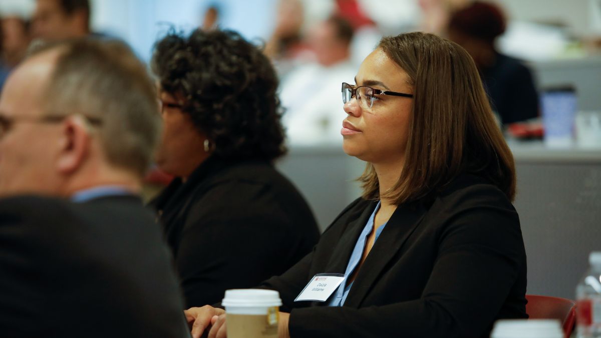 Participant engaging with faculty during workshop sessions.