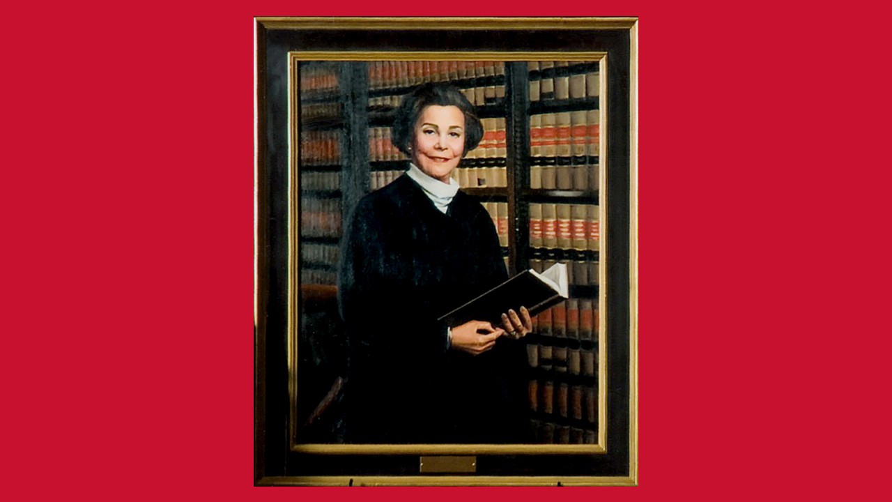 Justice Ruby Kless Sondock stands at center during a courthouse recognition ceremony with three women holding awards and a proclamation.